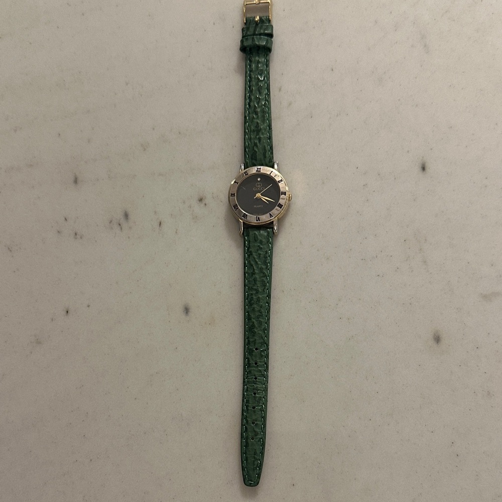 Gucci Black Dial Watch with Green Strap and Gold Details